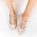 Beige shoes worn by a person on a white background, Obroi