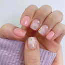 Close-up of a hand with pink floral nail design on a white background, Obroi