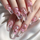 Nails with cherry blossom design on a white background