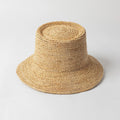 Beige straw hat on a light gray background, Obroi