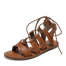 Brown leather sandal with criss-cross straps on a white background, Obroi