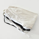 Folded metallic silver pants on a white background, Obroi