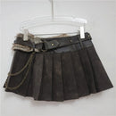 Black pleated skirt with fur trim and chain detail on a hanger against a white background, Obroi