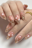 Nails with pink polish and floral designs on a neutral background, Obroi