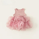 A baby girl's sleeveless dress featuring a dusty pink ribbed knit bodice with a small white embroidered 'Obroi' logo, and a voluminous layered pink tulle tutu skirt, laid flat on a light cream background.