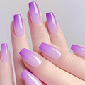 Hand with purple and pink gradient nail polish on a light gray background, Obroi