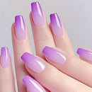 Hand with purple and pink gradient nail polish on a light gray background, Obroi