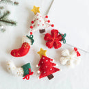 Felt Christmas ornaments on a white surface, Obroi