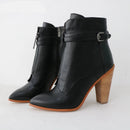 Black ankle boots with wooden heel on a white background, featuring the brand 'Obroi'.
