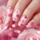 Nails with pink heart design on a blurred pink background, Obroi