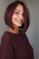 Woman with a stylish haircut and smile against a neutral background, Obroi