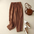 Brown pants with a brown handbag and white shoes on a beige background, Obroi