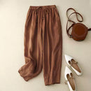 Brown pants with a brown handbag and white shoes on a beige background, Obroi