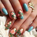 Nails with floral design and turquoise polish on a white fabric background, Obroi