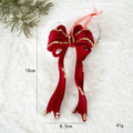 Red decorative bow with gold accents on a white background with measurements and weight displayed, Obroi