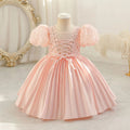 Pink dress on a mannequin against a decorative background, Obroi