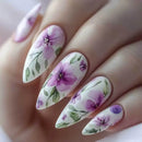 Nails with purple floral design on a white background, Obroi