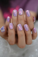 Hand with iridescent pink nail polish on a blurred background, Obroi