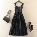 Black dress with matching handbag and high heels on a beige background, Obroi