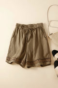 Brown shorts with lace trim on a light beige background, Obroi