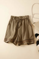 Brown shorts with lace trim on a light beige background, Obroi