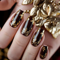 Nails with gold leaf design on a decorative background, Obroi