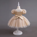Beige tulle dress with a bow on a mannequin against a gray background, Obroi