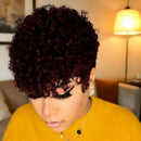 Person with curly dark hair wearing a yellow top in an indoor setting, Obroi