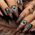 Nails with peacock feather and eye design on a wooden surface, Obroi