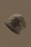 Brown beanie with a textured pattern on a brown background, Obroi