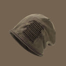 Brown beanie with a textured pattern on a brown background, Obroi