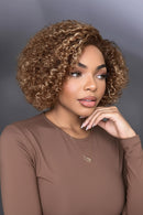 Woman with styled hair and close-up of a wig on a mannequin head, Obroi