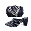 Black studded shoe and matching handbag set on a white background, Obroi