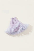 A sleeveless baby dress with a ruffled tulle skirt in a soft lavender and light blue gradient, laid flat on a warm cream background.
