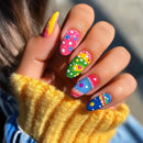 Colorful nail art on a hand with a blurred background, Obroi