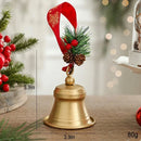 A small gold Christmas bell ornament with a red hanging ribbon, green pine sprigs, and pinecones, shown on a tabletop with dimension labels reading 10cm, 8cm, and 80g, Obroi