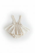 Beige baby romper with lace details on a light gray background, Obroi