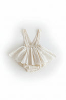 Beige baby romper with lace details on a light gray background, Obroi