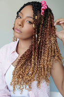 Woman with styled hair featuring ombre colors and a pink flower accessory, Obroi