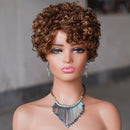 A mannequin bust wearing a short, voluminous curly wig in warm medium brown tones, styled with dangling earrings and a metallic fringe necklace against a soft gray background, Obroi