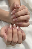 Close-up of hands with clear nail polish on a neutral background, Obroi