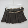 Black pleated skirt with fur trim and chain detail on a hanger against a white background, Obroi