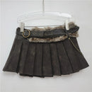 Black pleated skirt with fur trim and chain detail on a hanger against a white background, Obroi