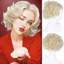 Woman with styled blonde hair next to a blonde wig on a mannequin head, Obroi