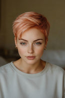 Woman with short, styled hair against a neutral background, Obroi