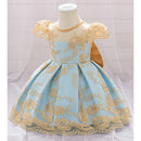 Light blue dress with gold floral embroidery on a mannequin against a white background, Obroi