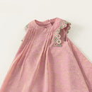 Pink dress with floral embroidery on a white background, featuring the brand 'Obroi'.