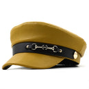 Mustard yellow cap with a black band featuring gold hardware on a white background, Obroi
