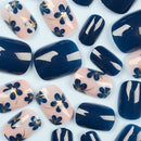 Nail art with blue floral designs on a white background, Obroi