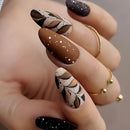 Hand with intricately designed nails featuring brown, black, and white patterns on a neutral background ,Obroi